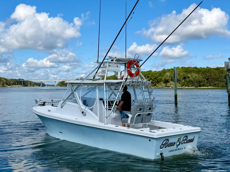Slide: The Image of Custom Carolina 27 National boat from 1973 on calm waters. - 4