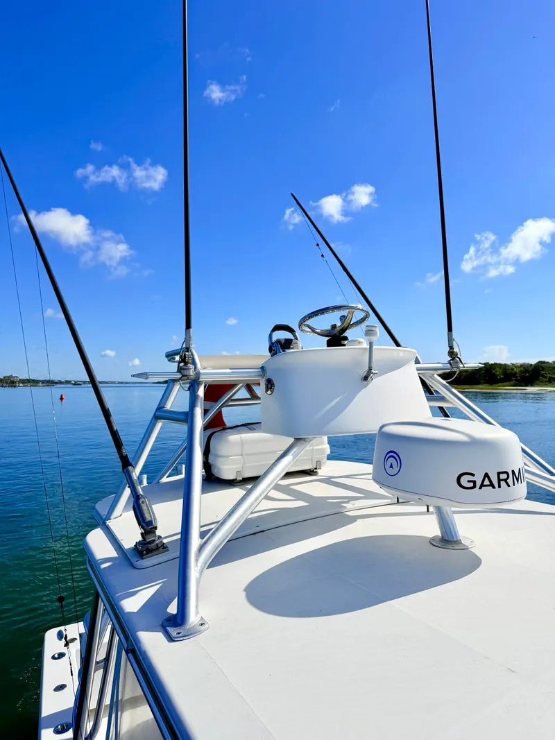 Slide: The Image of 1973 Custom Carolina 27 National boat on calm water. - 48
