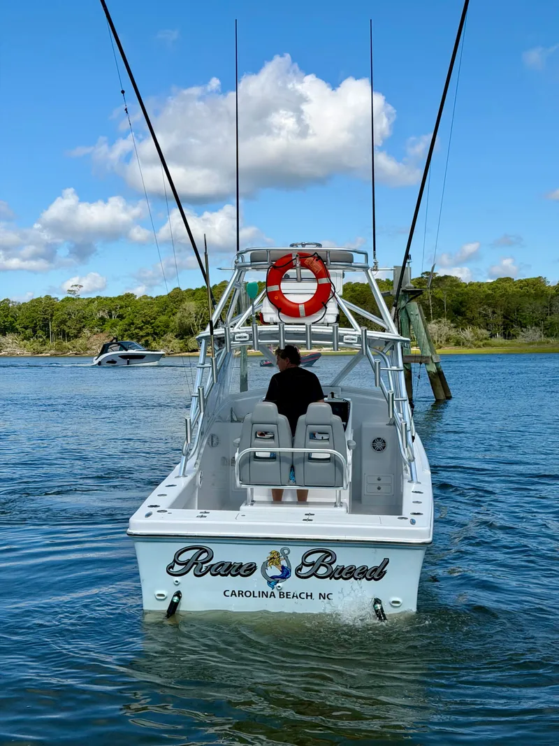Slide: The Image of Custom Carolina 27 National boat from 1973 on calm waters. - 5