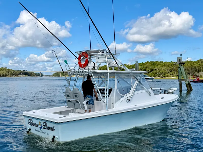 Slide: The Image of Custom Carolina 27 National 1973 boat on calm water. - 6