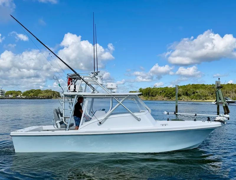 Slide: The Image of Custom Carolina 27 National 1973 boat on calm water. - 7