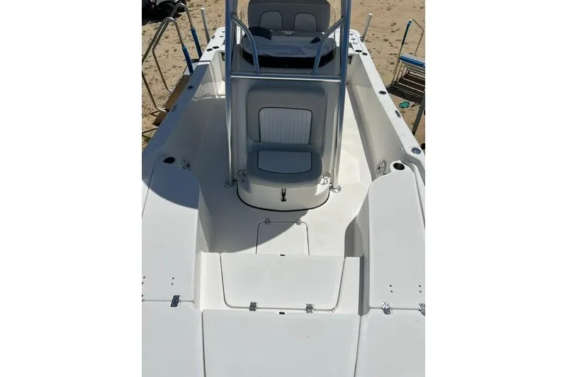 Slide: The Image of 2021 Sea Fox 220 Viper boat interior with seating and console, on sandy beach. - 12