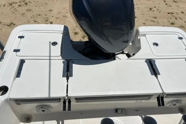 Slide: The Image of 2021 Sea Fox 220 Viper boat deck with motor, featuring storage compartments. - 2