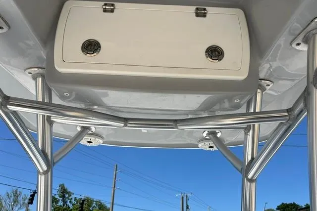 Slide: The Image of T-top storage compartment on a 2021 Sea Fox 220 Viper boat, with clear blue sky background. - 6