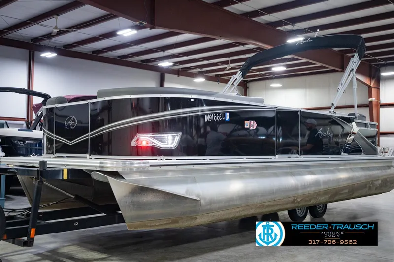 Slide: The Image of 2025 Avalon 2385 LSZ ENT pontoon boat in showroom, featuring sleek black design. - 1