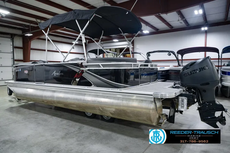 Slide: The Image of 2025 Avalon 2385 LSZ ENT pontoon boat with Suzuki outboard motor in a showroom. - 10