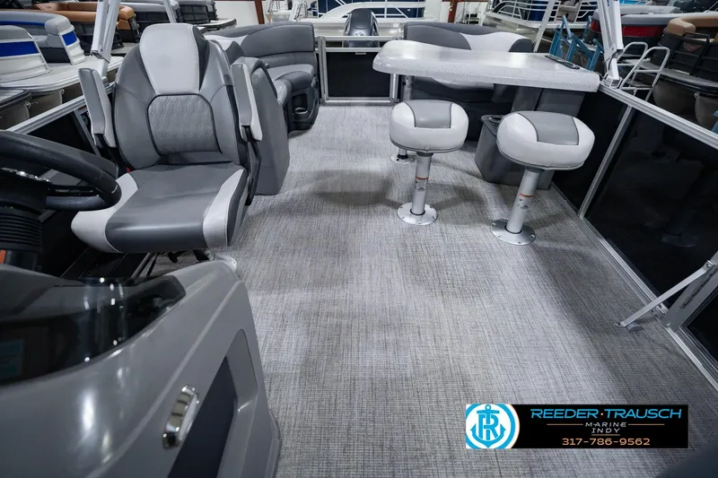 Slide: The Image of 2025 Avalon 2385 LSZ ENT pontoon boat interior with seating and table setup. - 20