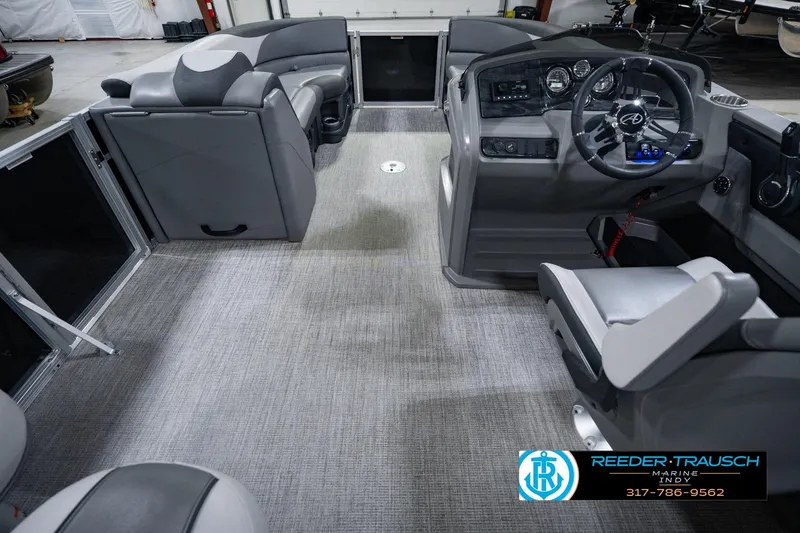 Slide: The Image of Interior of 2025 Avalon 2385 LSZ ENT pontoon boat with modern seating and steering console. - 24
