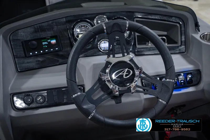 Slide: The Image of Steering wheel and dashboard of 2025 Avalon 2385 LSZ ENT boat, featuring modern controls. - 36