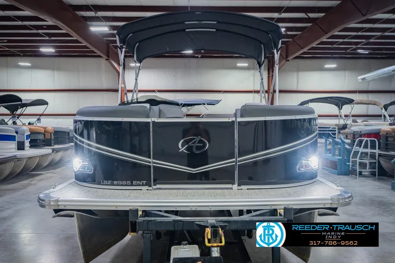 Slide: The Image of 2025 Avalon 2385 LSZ ENT pontoon boat in showroom, front view with canopy. - 4