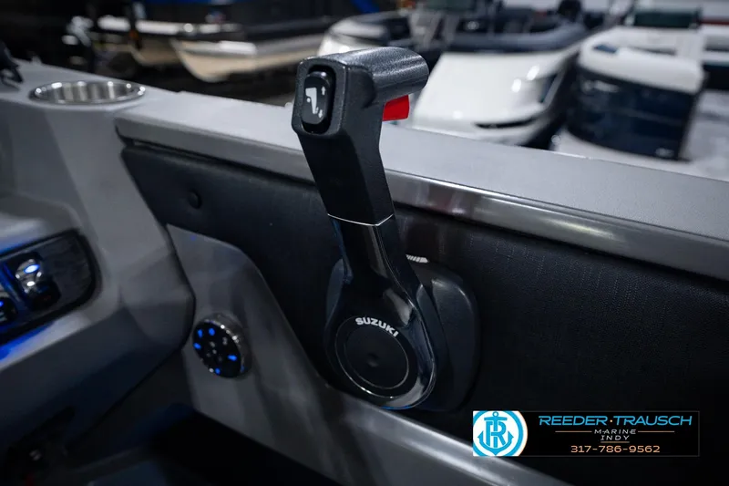 Slide: The Image of Throttle control of 2025 Avalon 2385 LSZ ENT boat with Suzuki branding, indoors. - 42