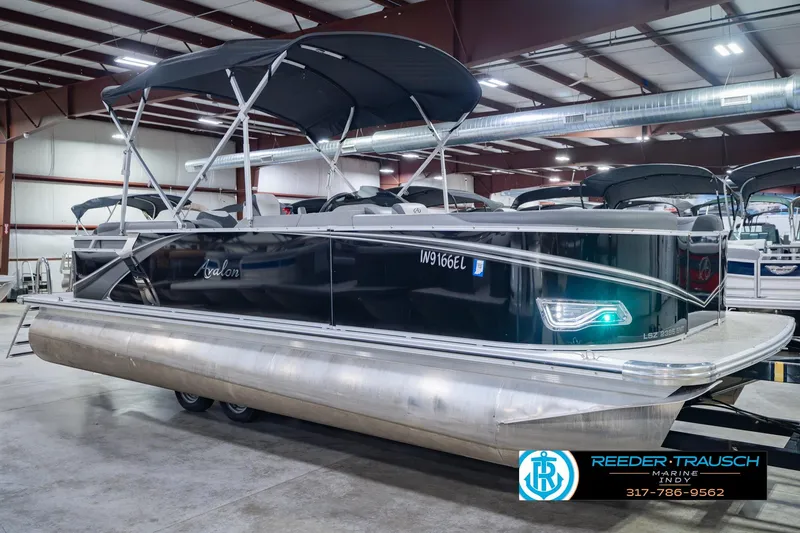 Slide: The Image of 2025 Avalon 2385 LSZ ENT pontoon boat in showroom with canopy and sleek design. - 5