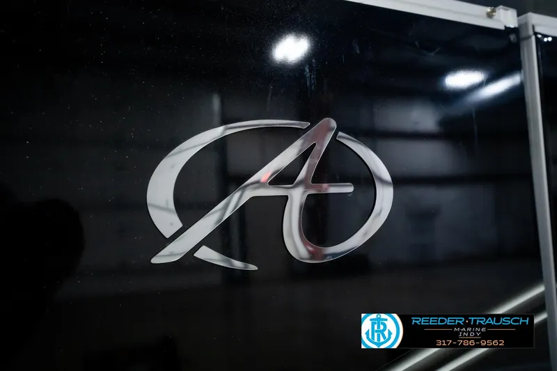 Slide: The Image of 2025 Avalon 2385 LSZ ENT logo on black surface, Reeder Trausch Marine contact details. - 56