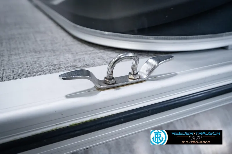 Slide: The Image of Stainless steel cleat on 2025 Avalon 2385 LSZ ENT boat deck, Reeder Trausch Marine logo visible. - 60