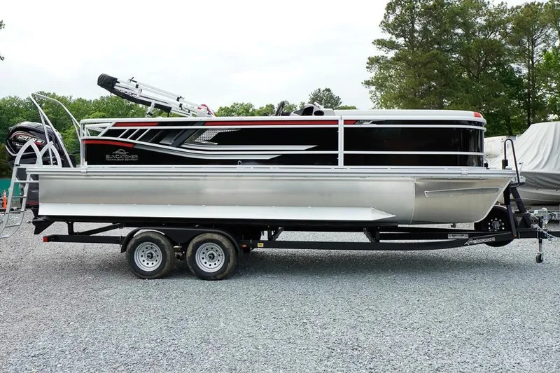 The Image of 2026 SunCatcher Select 322SL pontoon boat on trailer, parked on gravel lot. - 1