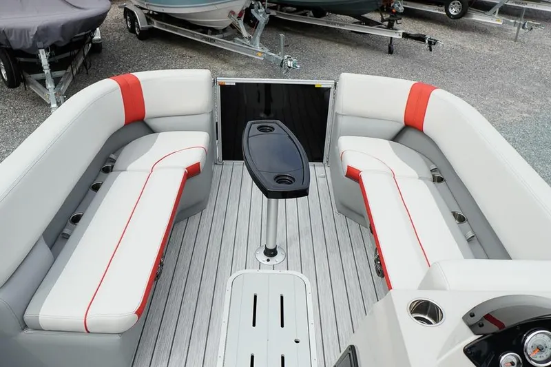 Slide: The Image of 2026 SunCatcher Select 322SL boat interior with gray and red seating, central table. - 12