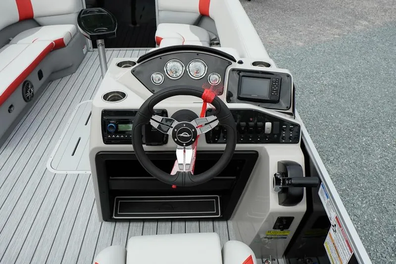 Slide: The Image of 2026 SunCatcher Select 322SL boat dashboard with steering wheel and navigation controls. - 19