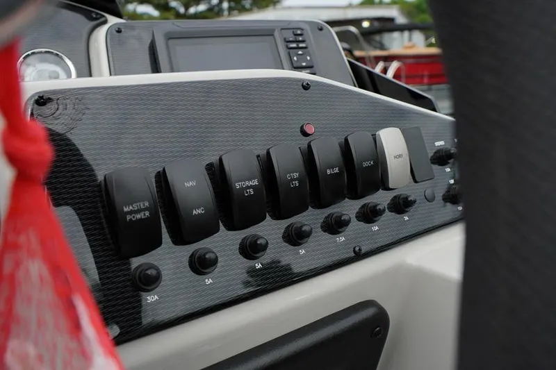 Slide: The Image of Control panel of 2026 SunCatcher Select 322SL boat with switches and buttons. - 28