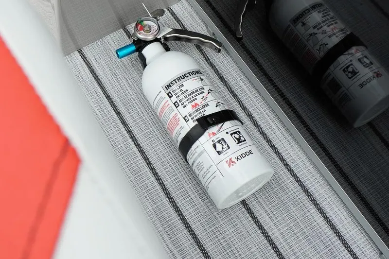 Slide: The Image of Fire extinguisher on SunCatcher Select 322SL boat, 2026 model, with safety instructions visible. - 31