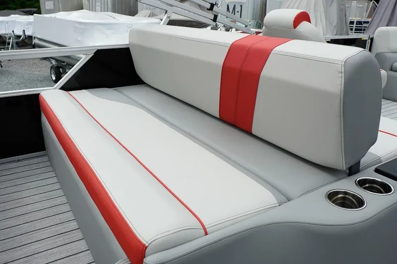 Slide: The Image of 2026 SunCatcher Select 322SL boat seat with red accents and cup holders. - 34