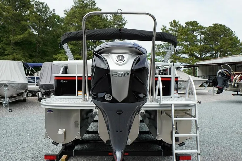 Slide: The Image of 2026 SunCatcher Select 322SL pontoon boat with powerful outboard motor, parked outdoors. - 4