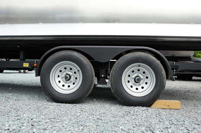 Slide: The Image of Trailer wheels of 2026 SunCatcher Select 322SL on gravel surface. - 44