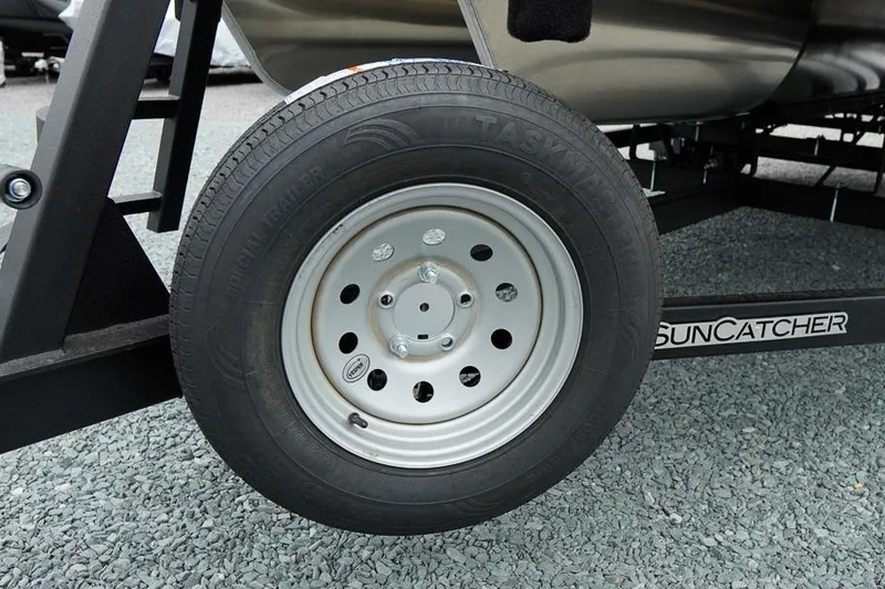 Slide: The Image of Trailer wheel of 2026 SunCatcher Select 322SL on gravel surface. - 46