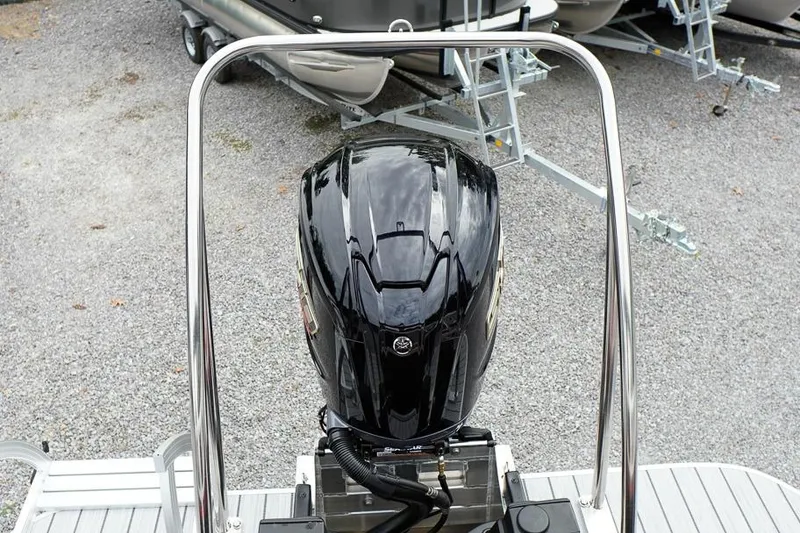 Slide: The Image of 2026 SunCatcher Select 322SL boat engine, sleek black design, parked on gravel. - 5