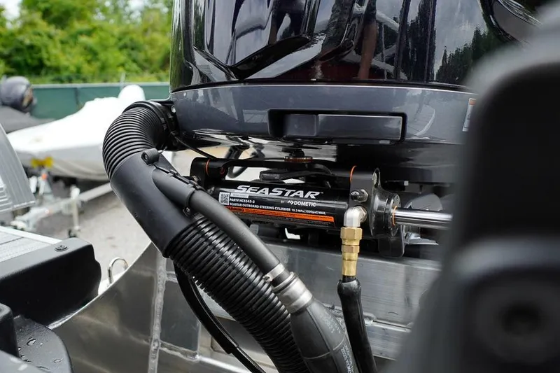Slide: The Image of Close-up of SeaStar hydraulic steering system on 2026 SunCatcher Select 322SL boat. - 6