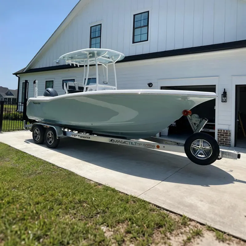 The Image of 2023 Tidewater 220 LXF boat on trailer in front of garage. - 0