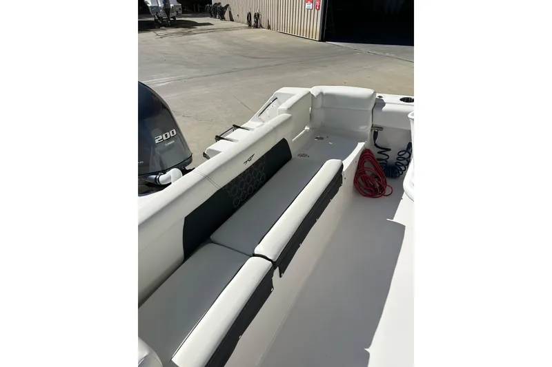 Slide: The Image of 2023 Tidewater 220 LXF boat interior with seating and Yamaha 200 engine. - 11