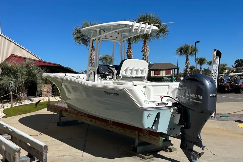 Slide: The Image of 2023 Tidewater 220 LXF boat with Yamaha engine, displayed outdoors under clear blue sky. - 5
