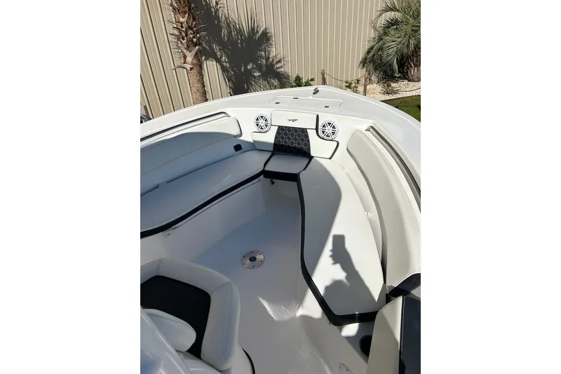 Slide: The Image of 2023 Tidewater 220 LXF boat interior with cushioned seating and speakers. - 9