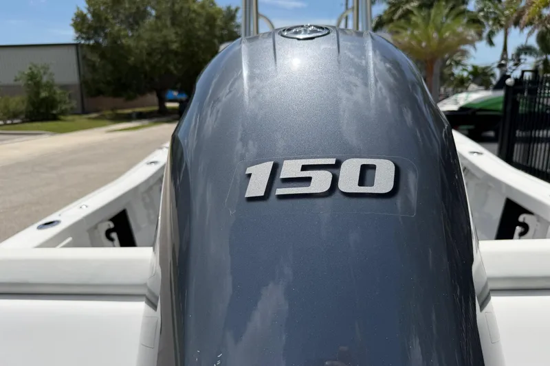 Slide: The Image of 2023 Tidewater 198 CC Adventure boat with 150 horsepower engine, outdoor setting. - 10