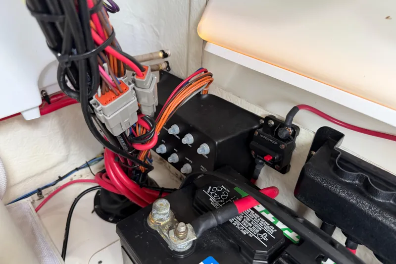 Slide: The Image of Electrical wiring and battery setup in a 2023 Tidewater 198 CC Adventure boat. - 102