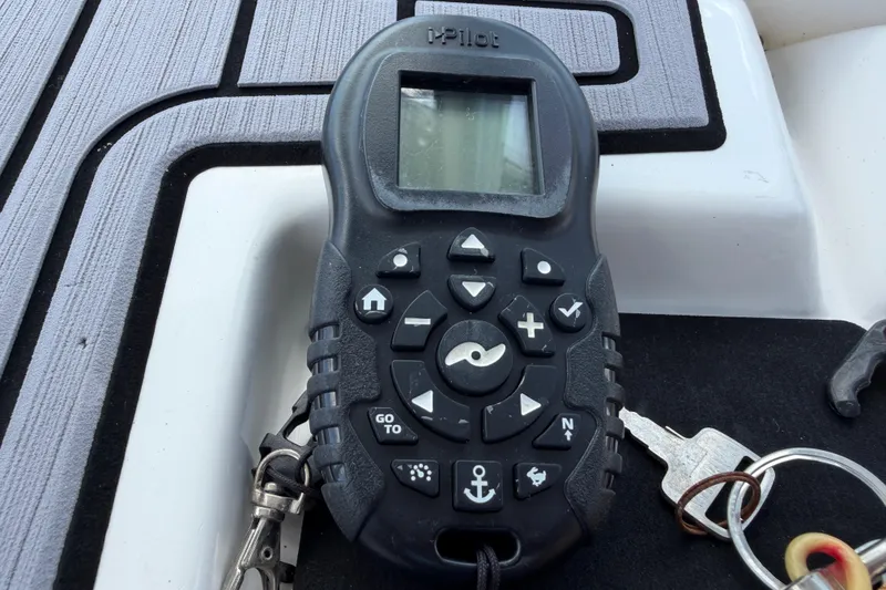 Slide: The Image of Remote control on a 2023 Tidewater 198 CC Adventure boat deck with keys attached. - 105