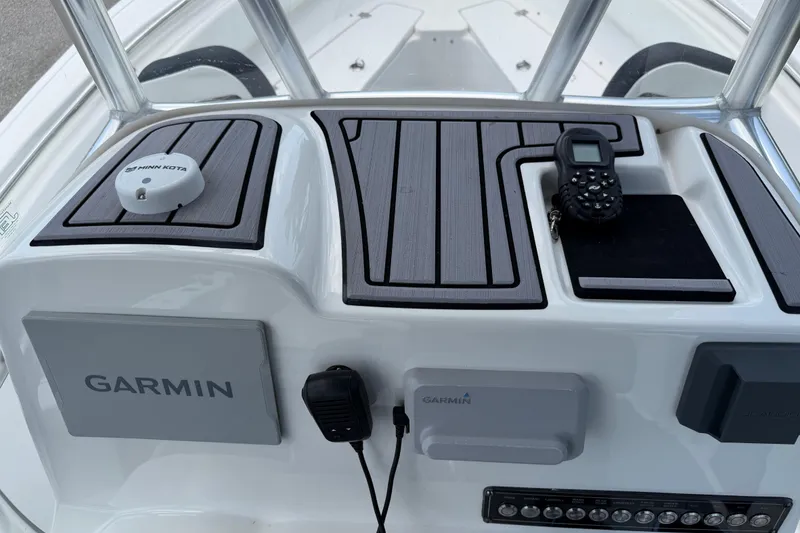Slide: The Image of Control panel of 2023 Tidewater 198 CC Adventure boat with Garmin and Minn Kota devices. - 106
