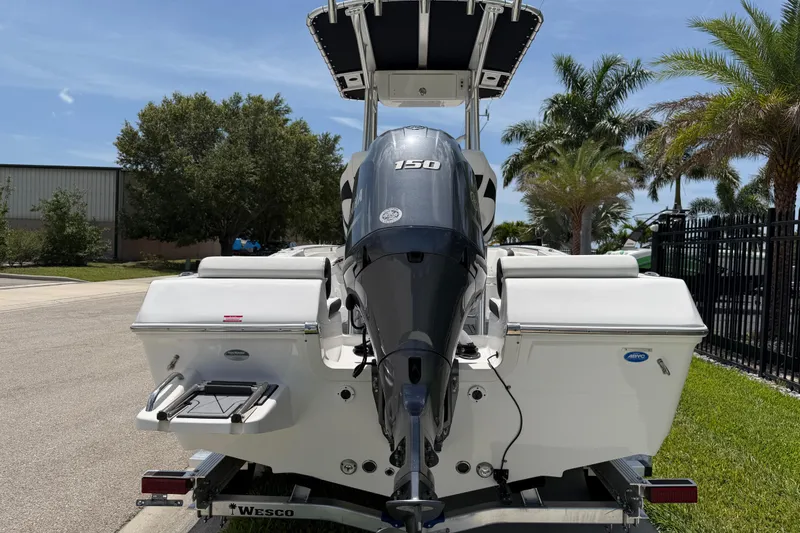 Slide: The Image of 2023 Tidewater 198 CC Adventure boat with powerful outboard motor, parked outdoors. - 11