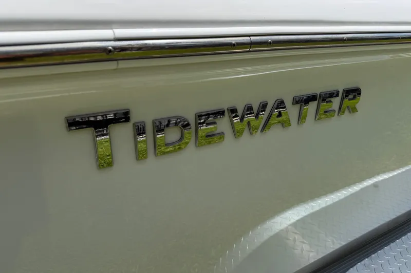 Slide: The Image of 2023 Tidewater 198 CC Adventure boat logo on sleek white surface. - 14