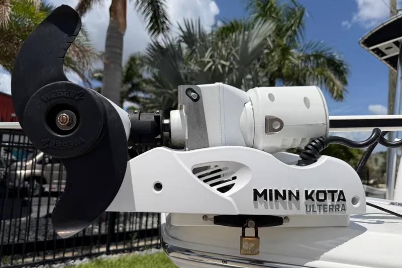 Slide: The Image of Minn Kota Ulterra motor on 2023 Tidewater 198 CC Adventure boat, palm trees in background. - 19