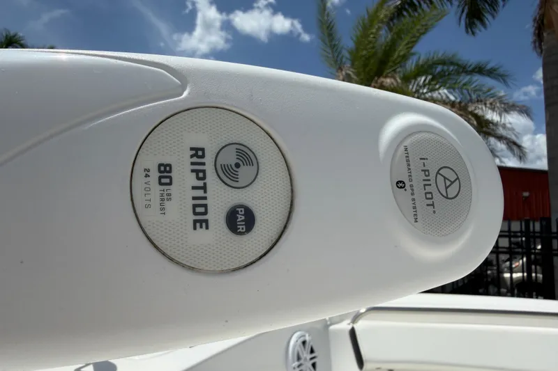 Slide: The Image of Tidewater 198 CC Adventure 2023 boat with Riptide i-Pilot GPS system under blue sky. - 21