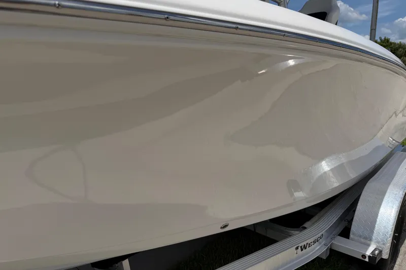 Slide: The Image of 2023 Tidewater 198 CC Adventure boat on trailer, showcasing sleek hull design. - 24