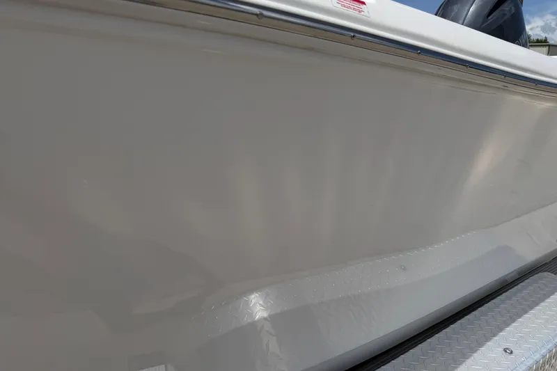 Slide: The Image of 2023 Tidewater 198 CC Adventure boat hull close-up, showcasing sleek design and metallic finish. - 25