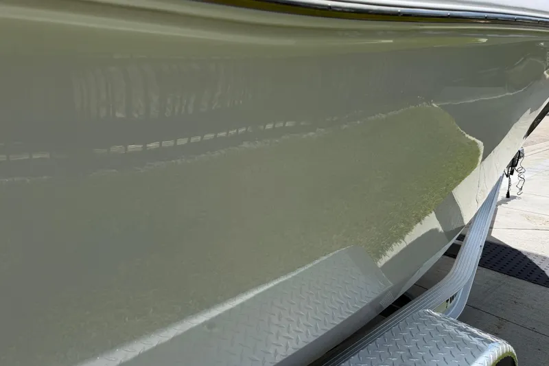 Slide: The Image of 2023 Tidewater 198 CC Adventure boat hull on a trailer, reflecting sunlight. - 28