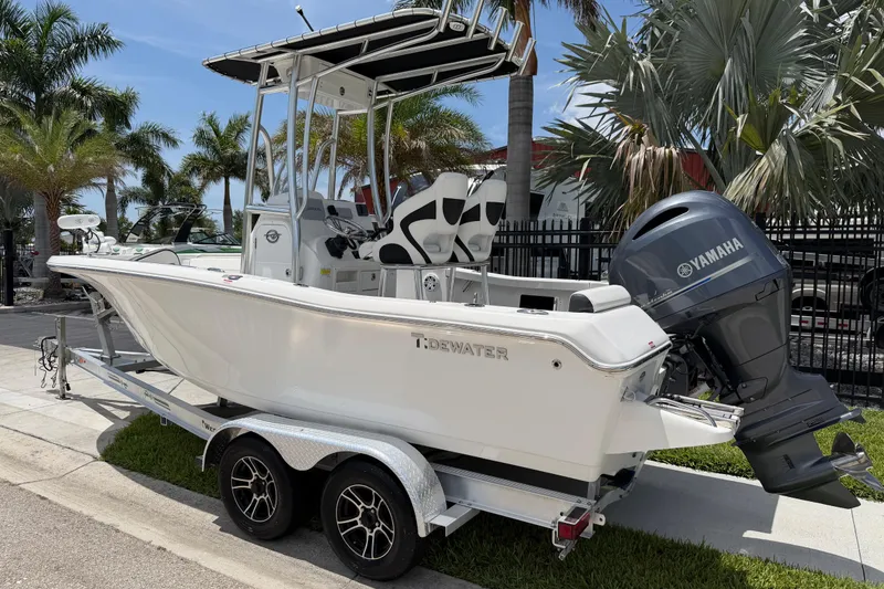 Slide: The Image of 2023 Tidewater 198 CC Adventure boat with Yamaha engine on trailer, surrounded by palm trees. - 3