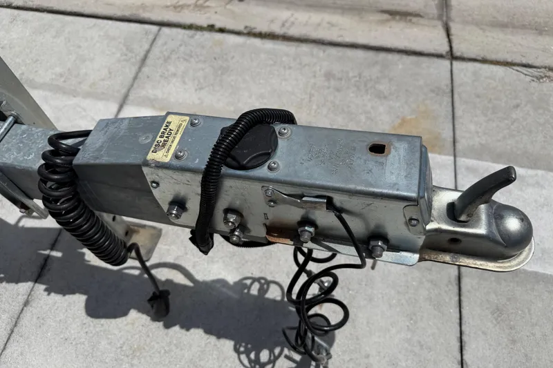 Slide: The Image of Trailer hitch mechanism for 2023 Tidewater 198 CC Adventure boat on concrete surface. - 31