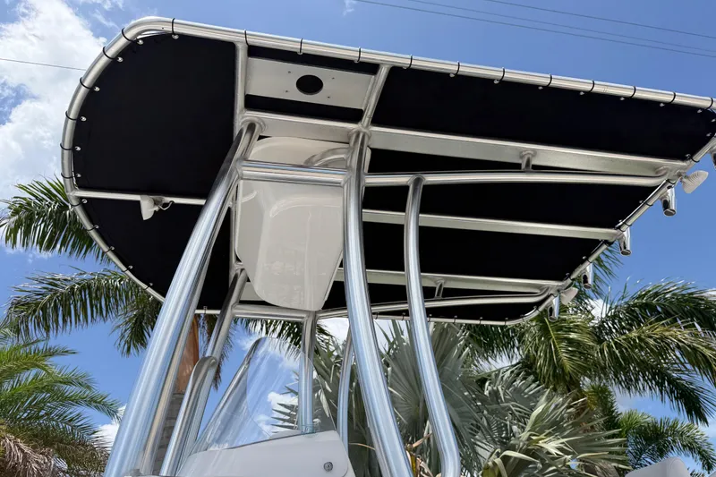 Slide: The Image of 2023 Tidewater 198 CC Adventure boat T-top against a clear blue sky. - 34
