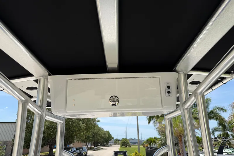 Slide: The Image of Tidewater 198 CC Adventure 2023 boat T-top with storage compartment and control panel. - 35
