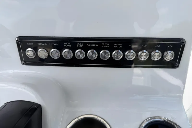 Slide: The Image of Control panel of 2023 Tidewater 198 CC Adventure boat with labeled buttons. - 36