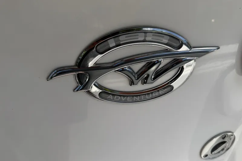 Slide: The Image of Chrome emblem of 2023 Tidewater 198 CC Adventure boat on white surface. - 47